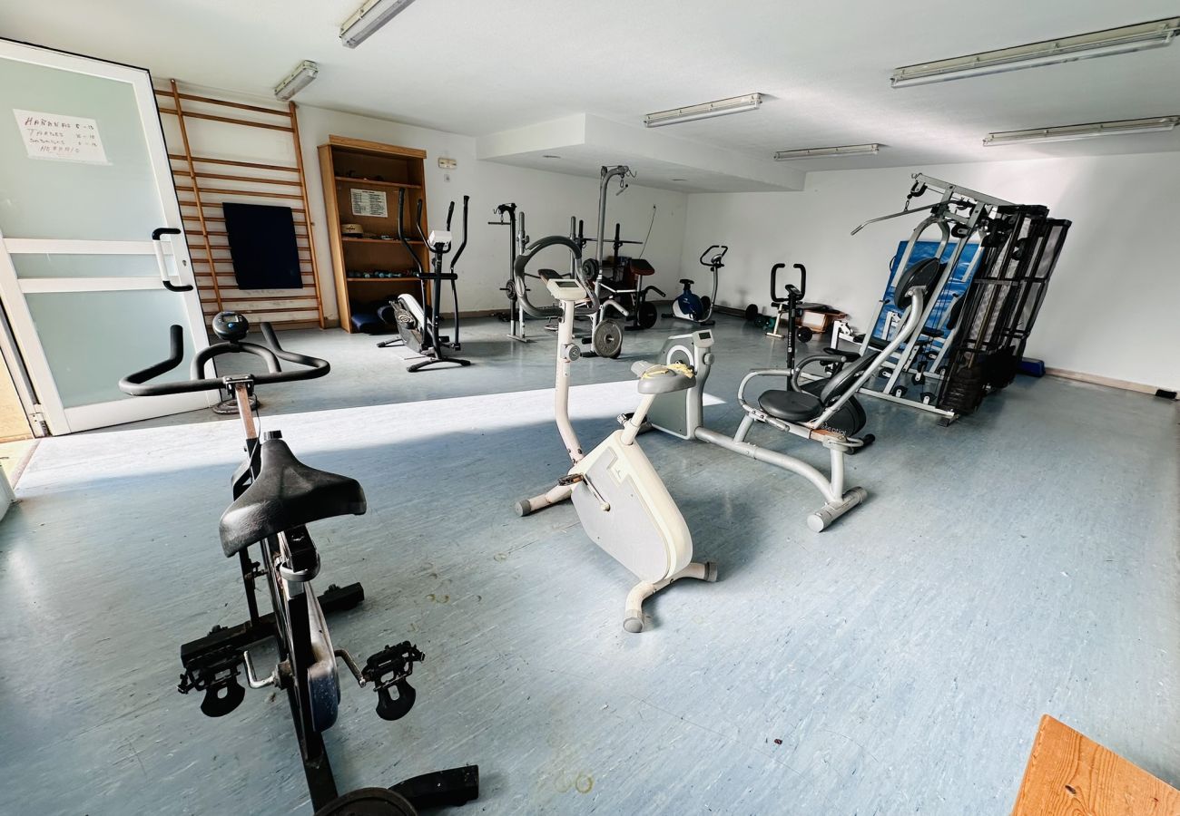 Gimnasio con bicicleta estáticas y máquinas en apartamento en Cala de Finestrat