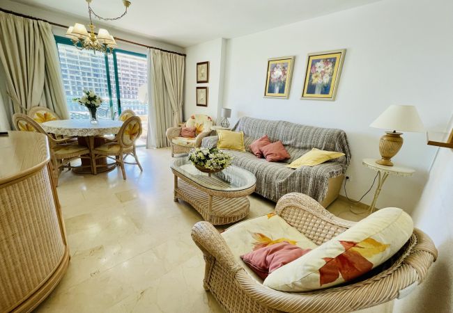 Spacious living room with large sofas and round table.