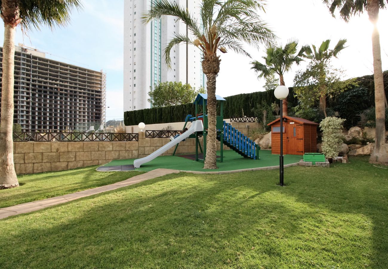 Children's playground with natural grass in the holiday flat in Alicante