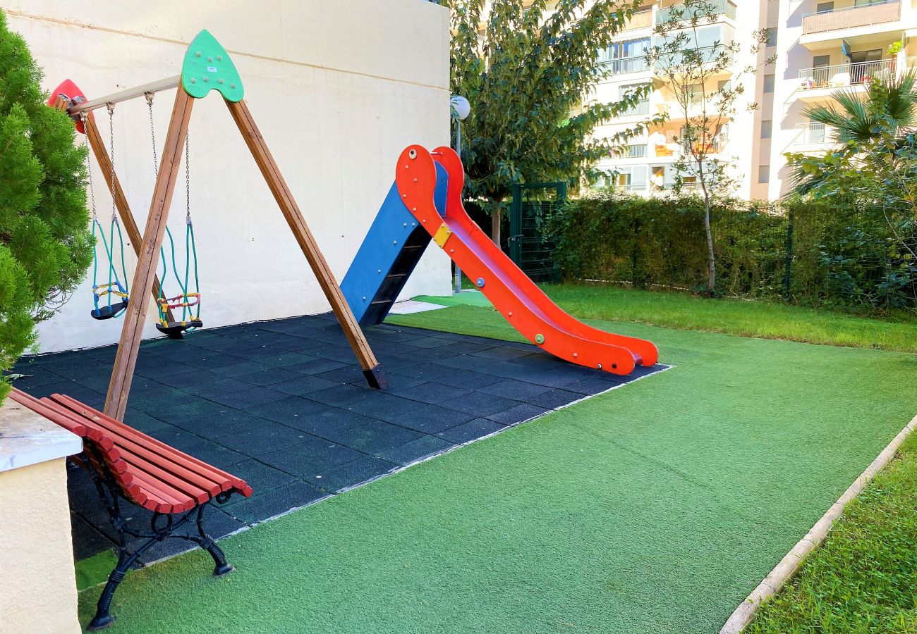 Children's playground with artificial grass in the holiday flat