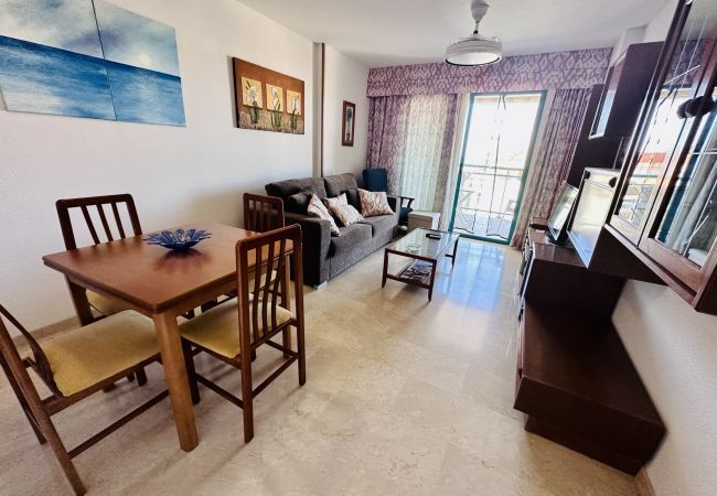 Bright dining room with sofa and television of the holiday flat in Alicante